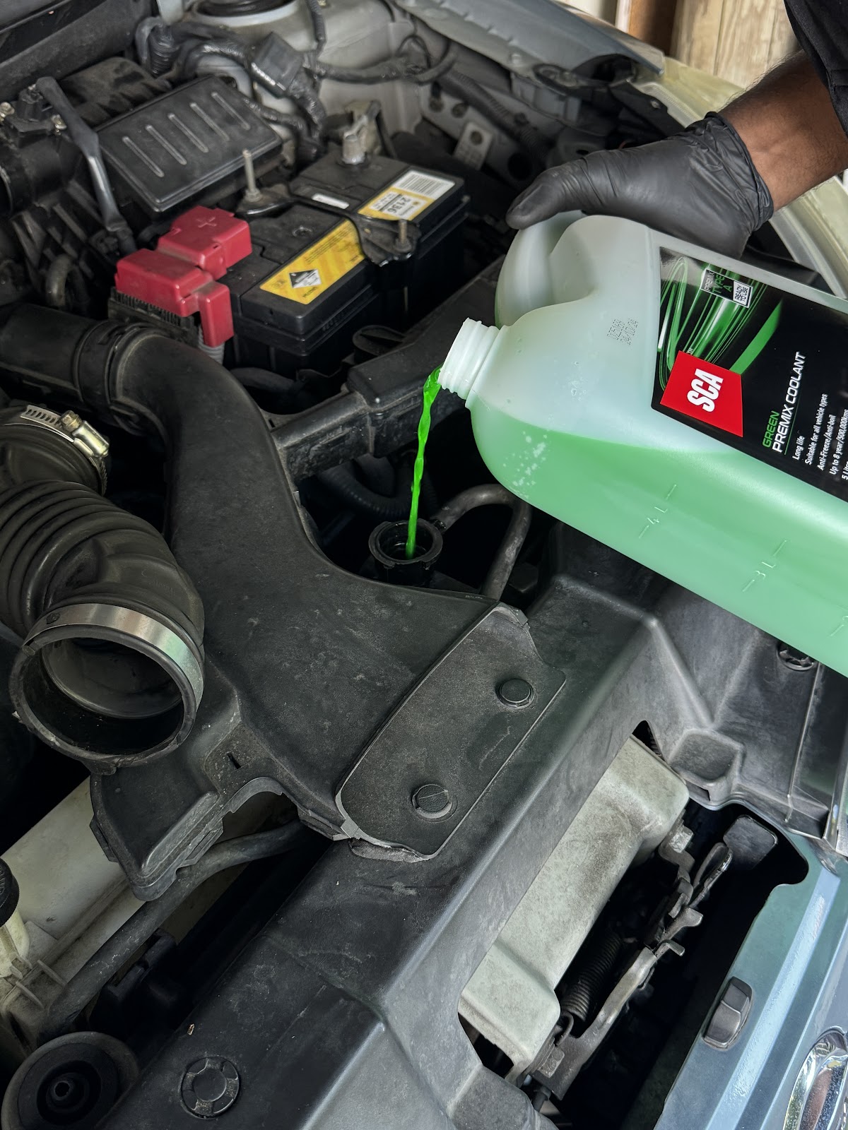 Topping up coolant during a mobile service