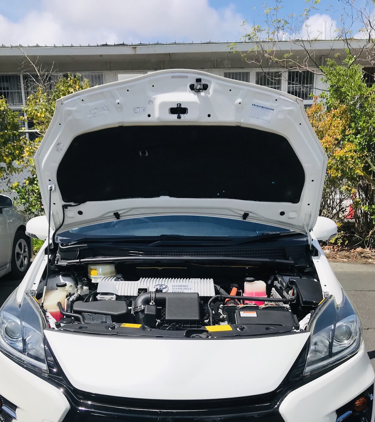 Hybrid engine bay with the bonnet up during a service